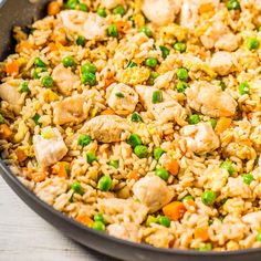 a pan filled with rice and vegetables on top of a table