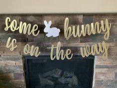 a fireplace with some bunny is on the way written in gold foil and an image of a rabbit