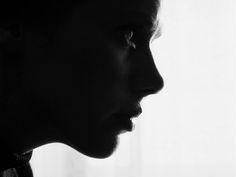 a black and white photo of a woman's profile with her nose slightly open