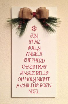 a cross stitch christmas tree card hanging on a wall