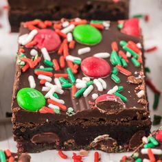 two pieces of chocolate cake with sprinkles and candy