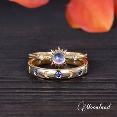 two gold rings with blue and white stones