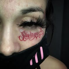 a woman with red writing on her face