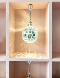 four different views of a disco ball hanging from a light fixture in a pink room