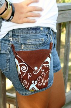 a woman's jeans shorts with a brown and white purse on the back pocket