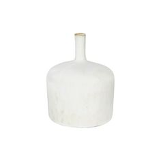 a white vase sitting on top of a table