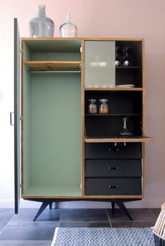 an open cabinet with shelves and drawers on it