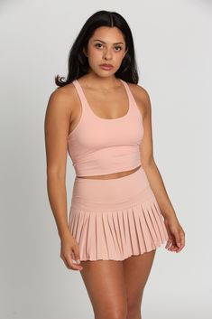 Our Peach Racerback Crop Tank features a slight cropped fit and racerback style that is the perfect go-to athletic top. It is complete with sweat-wicking material and a double layer, built-in-removable padded bra. 75% Nylon, 25% Spandex Built in / Removable Padding Model Details: Modeled in size: Small Model Waist: 30 Model Bust: 34 Model Height: 5'6 Sporty Racerback Crop Top With Built-in Bra, Sports Tank Crop Top With Built-in Bra, Athleisure Scoop Neck Crop Top With Built-in Bra, Athleisure Crop Top With Built-in Bra And Scoop Neck, Athleisure Crop Top With Built-in Bra For Light Sports, Solid Scoop Neck Crop Top For Sports, Solid Color Scoop Neck Crop Top For Sports, Medium Support Scoop Neck Crop Top For Sports, Sports Crop Top With Built-in Bra And Scoop Neck