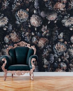 an ornate chair sits in front of a floral wallpaper