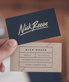 a person holding up a business card that says nick reese on the front and back