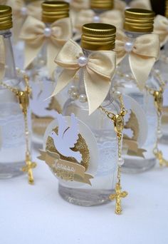 several bottles with gold and white decorations on them, one has a name tag attached to the bottle