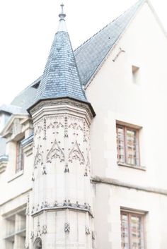 an old building with a clock tower on the front and side of it's face