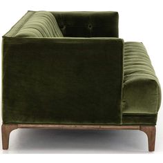 a green couch sitting on top of a wooden frame