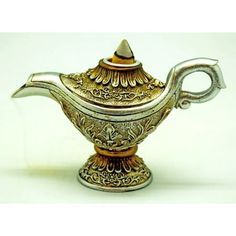 an ornate silver teapot on a white background