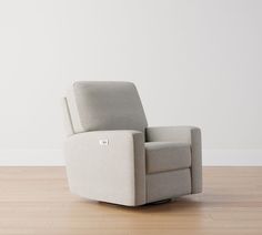 a recliner chair sitting on top of a hard wood floor next to a white wall