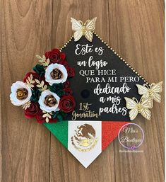 a graduation cap decorated with flowers and butterflies