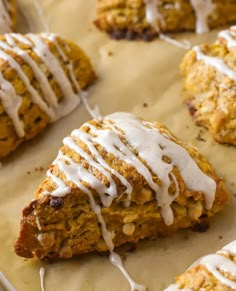 several scones with white icing on top of them