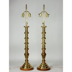 a pair of brass candlesticks on wooden bases