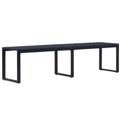 a black bench sitting on top of a white wall