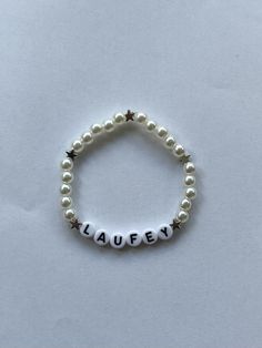 a beaded bracelet with the word laufey written in small letters on it