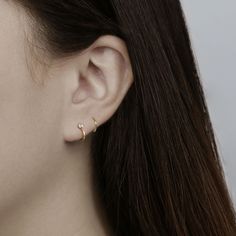 Material: 14k Solid Gold, Clear Cubic Zirconia Size: 7 mm Inner Diameter, 2.5mm CZ Color: Yellow Gold, Rose Gold Style: Latch-Back Hoop Earring All jewelry comes in a gift-ready box. Cartilage Helix Piercing, Labret Studs, Cartilage Earrings Hoop, Cartilage Hoop, Tiny Earrings, Cz Stud Earrings, Huggie Hoop Earrings, Single Earring, Jewelry Earrings Hoops