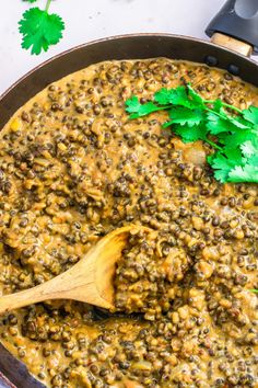 a pot filled with lentils and topped with parsley