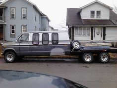 a truck that is parked in front of some houses on the side of the road