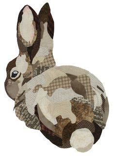 an animal made out of patchwork fabric on a white background with the image of a rabbit