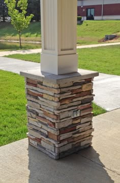 a stone pillar sitting on top of a sidewalk