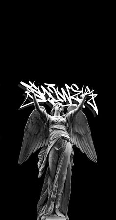 an angel statue with graffiti on it's back and wings in the air, against a black background