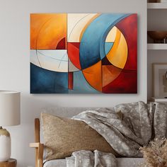 an abstract painting hangs on the wall above a couch in a room with white walls