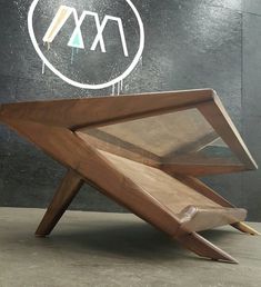 a small wooden object sitting on top of a table next to a sign that says m & w