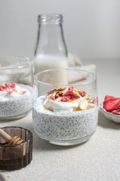 two glasses filled with oatmeal and strawberries