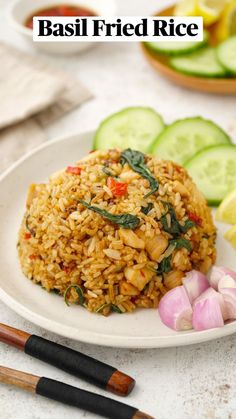 a white plate topped with rice next to sliced cucumbers