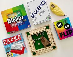 four different types of wooden toys are arranged on a white surface with bananas and other items