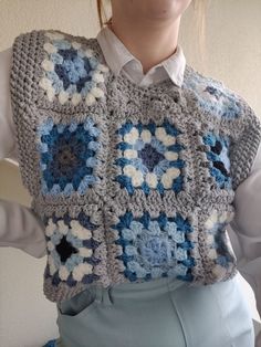 a woman wearing a crocheted granny granny sweater