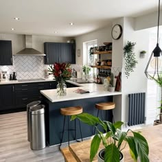 a kitchen filled with lots of counter top space next to a metal refrigerator freezer