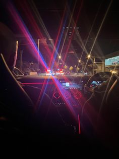 the interior of a car with red, white and blue lasers on it's dash lights