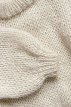 the texture of a white knitted sweater