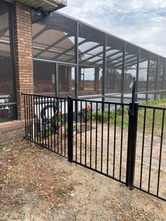 a black metal fence next to a building