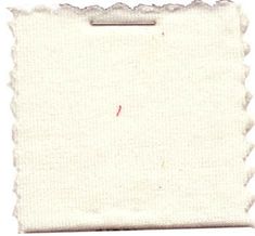 a white piece of cloth with scalloped edges and a small red stitch on the bottom