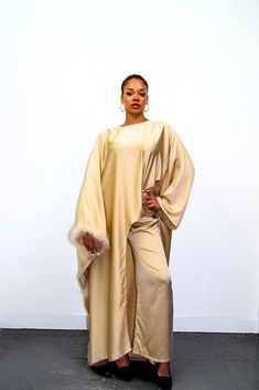 Embrace timeless elegance with our exquisite Satin Abaya Co-Ord Set. This stunning two-piece ensemble features a luxurious, soft-flowing satin fabric that drapes beautifully and flatters your figure. The elegant abaya boasts a modest silhouette, perfect for everyday wear or special occasions. The highlight of this set is the exquisite fur trim. This touch of luxury adds a touch of sophistication and warmth to the design, making it perfect for cooler evenings or formal events. Key Features Luxurious Satin Fabric: Experience the soft, smooth feel of premium satin that flatters your form. Elegant Abaya Silhouette: This modest design offers full coverage while maintaining a stylish and graceful drape. Delicate Fur Trim: Elevate your look with a touch of luxury and warmth. Two-Piece Co-Ord Set: Elegant Solid Color Abaya For Eid, Formal Long Sleeve Silk Abaya, Elegant Floor-length Solid Abaya, Luxury Long Sleeve Evening Abaya, Eid Evening Solid Color Abaya, Elegant Floor-length Abaya For Eid, Evening Solid Color Maxi Length Abaya, Evening Solid Maxi Length Abaya, Evening Maxi Length Solid Abaya