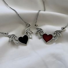 These matching silver heart necklaces feature gothic black & red heart wing pendants, representing grunge jewelry, perfect for gifting to your best friend or her, particularly those who cherish unique gothic accessories. 𝐃𝐄𝐓𝐀𝐈𝐋𝐒:  ⭐️ Necklace lengths available 14" 16" 18" ⭐️ Pendant size is 2 1/8" x 7/8"  ⭐️ The heart wing pendants are silver plated over alloy. The chain necklace is made up of high quality stainless steel, made to last long with proper care ⭐️ The cutest best friend jewel Heart Stone Jewelry, Black Heart Jewelry, Best Friend Matching Jewelry, Gothic Heart Pendant Jewelry, Gothic Metal Heart Necklace, Silver Wing-shaped Necklace For Valentine's Day, Emo Heart Pendant Metal Necklaces, Emo Heart Pendant Metal Necklace, Gothic Metal Heart Necklace For Valentine's Day