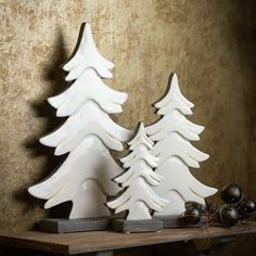 two white ceramic trees on a table