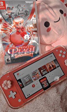 a nintendo wii game system next to a pink teddy bear and dvd's case