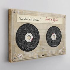 a wooden wall hanging with two old fashioned records on it