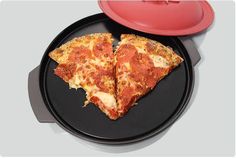 two slices of pizza sitting on top of a black plate next to a red bowl