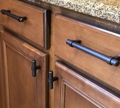 a kitchen with wooden cabinets and granite counter tops on top of eachother's backsplash