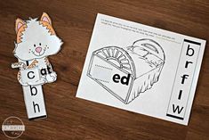 an orange and white cat is next to a cut out of the letter b with its name on it