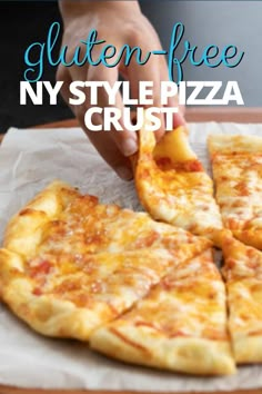 a person grabbing a piece of cheese pizza from a tray with the text gluten - free ny style pizza crust